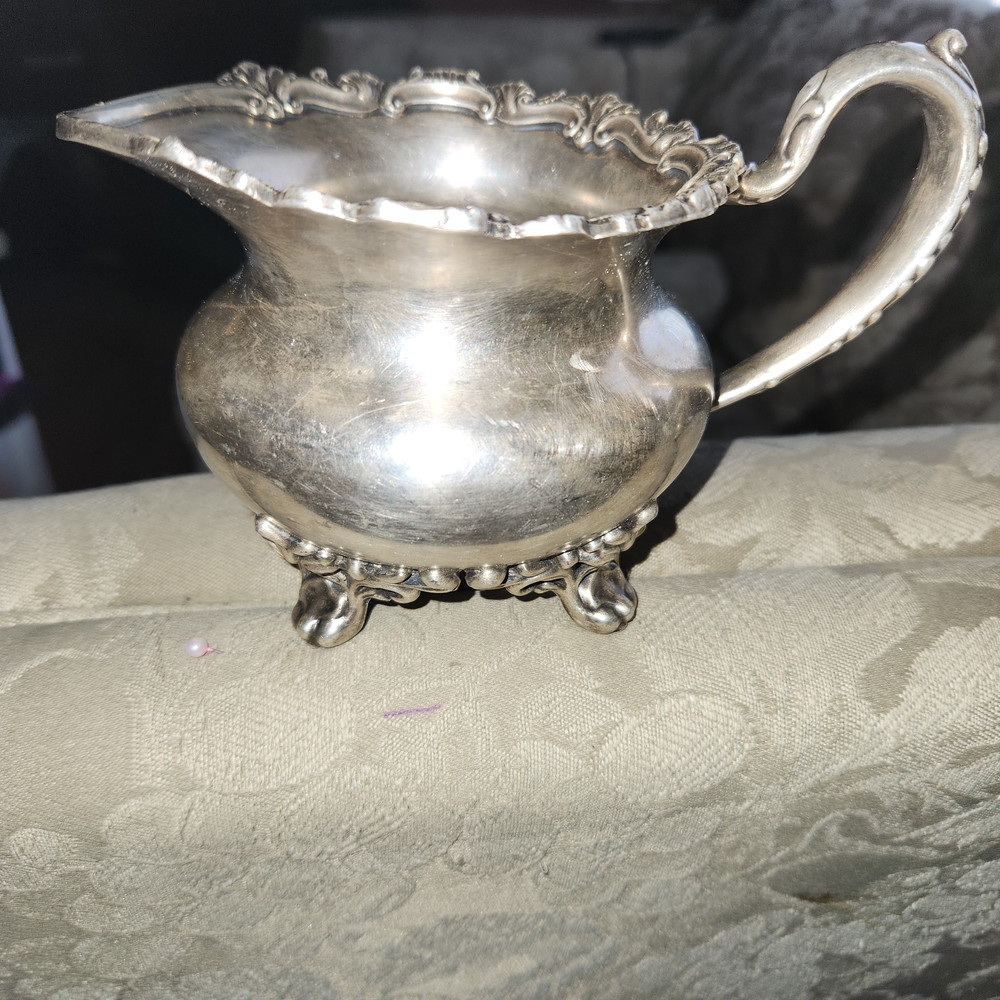 Elegant Silver Creamer with Ornate Handle